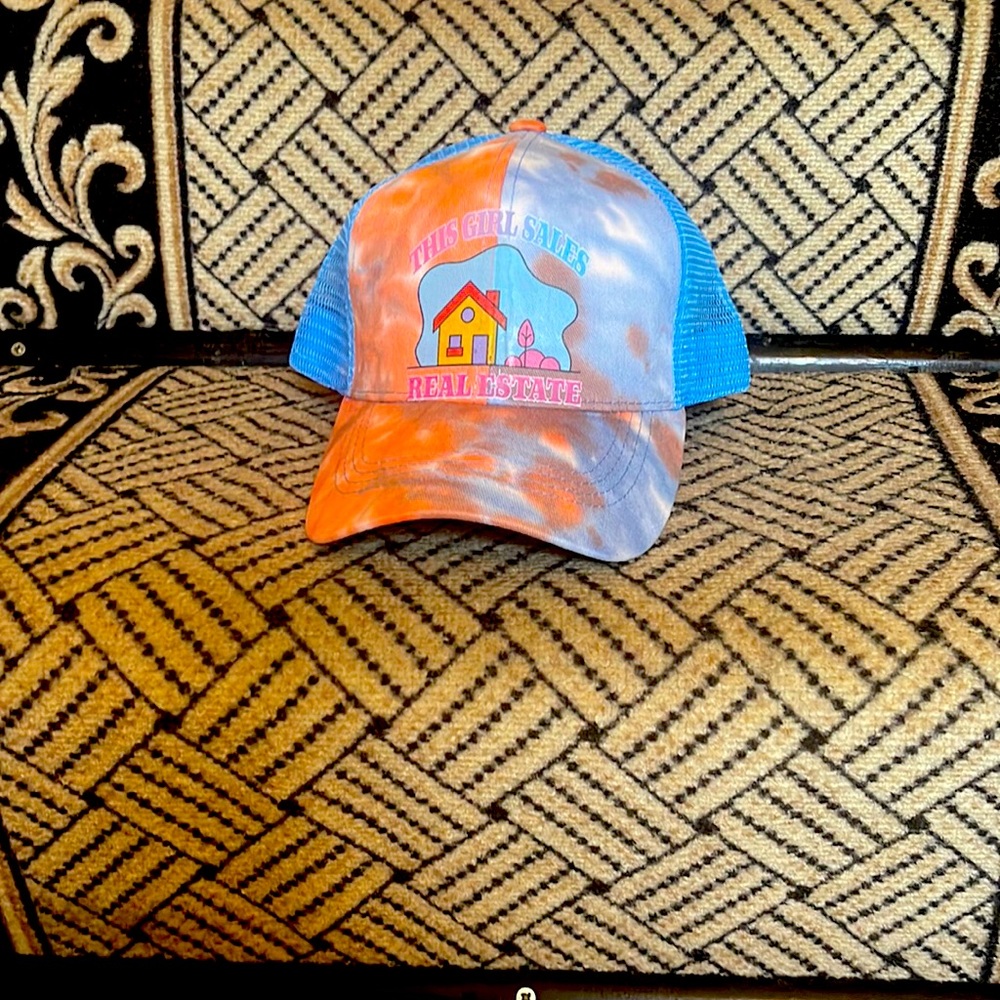 Trucker hat, with ponytail eyelet, adjustable snap back.
